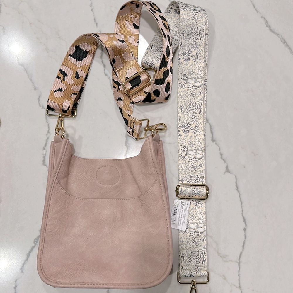 Blush pink faux leather crossbody bag with interchangeable reversible straps